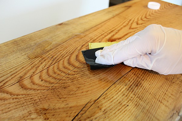using wet sandpaper to apply tung oil to wood