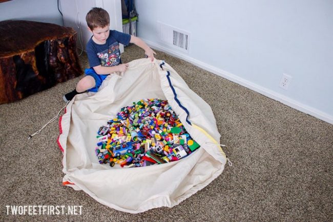 kid opening large lego mat