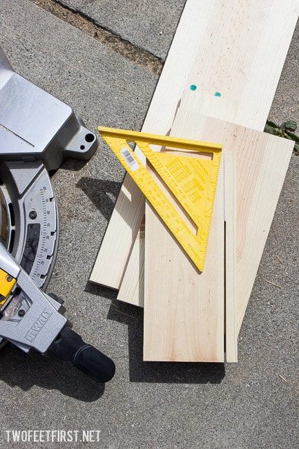 cutting a piece of wood with a miter saw for stool