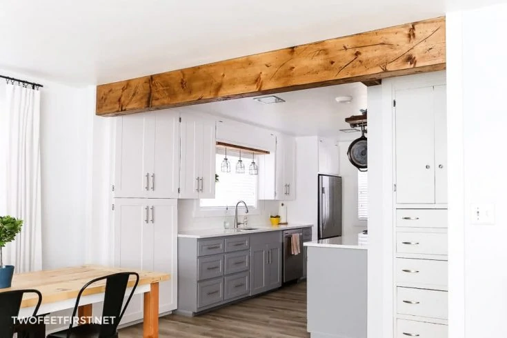 wood beam between kitchen and living room to create open space