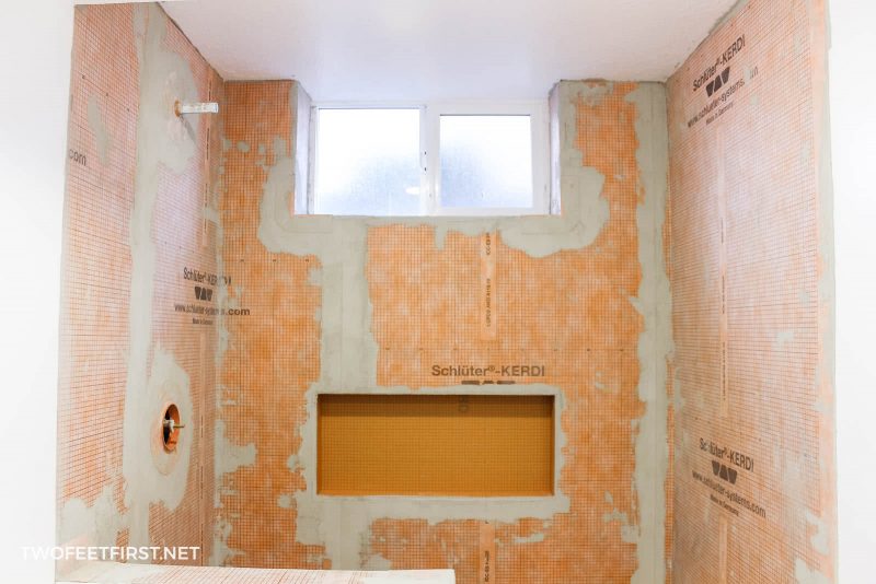 orange Schluter Kerdi shower membrane installed