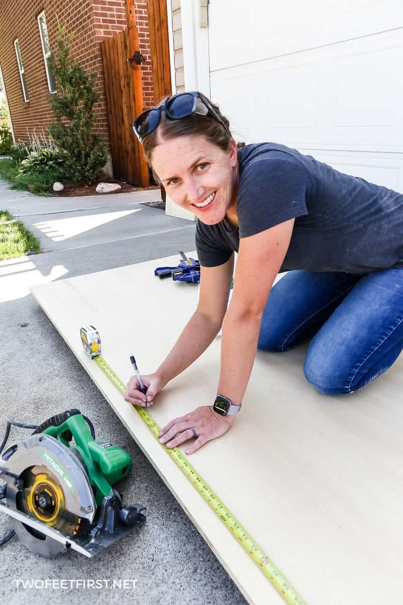 owner of TwoFeetFirst measuring plywood