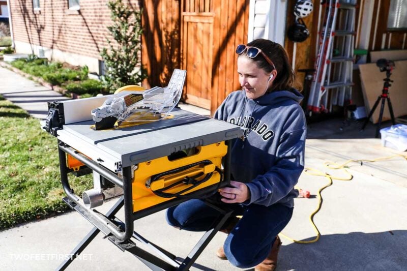 women setting up portable table saw