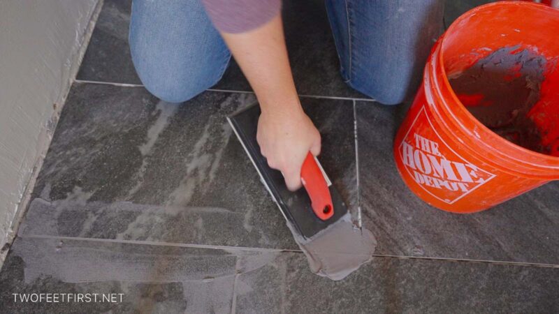 apply grout to black bathroom floor tile