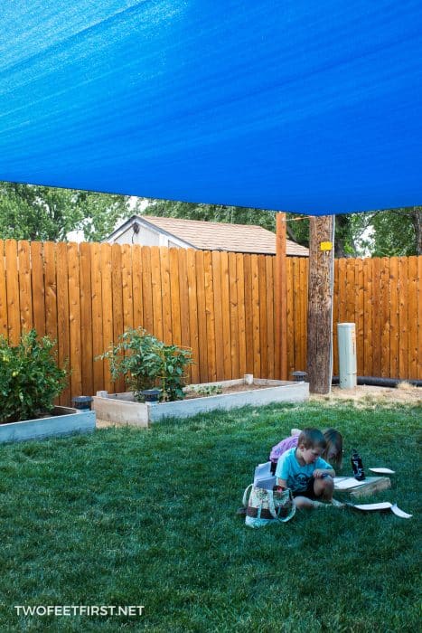 how to install sun shade sail in yard with kids playing under the shade