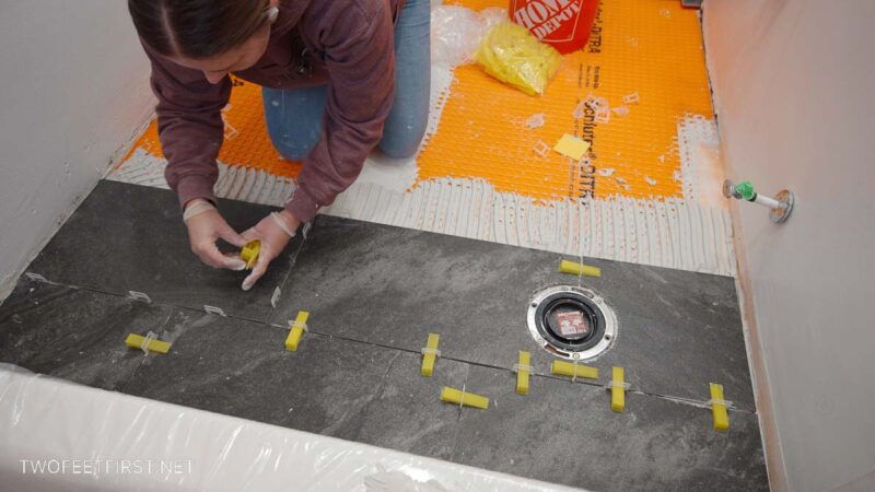 placing self leveling spacers on floor tile