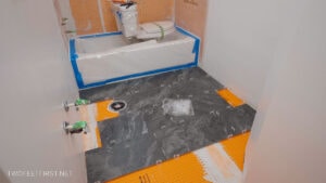 black tiles on bathroom floor with DIY tile install